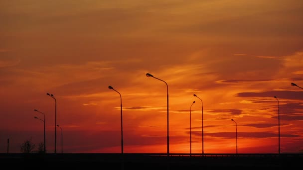 Cars silhouettes on road against sunset - timelapse — Stock Video