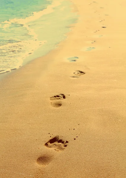 Footprints on beach - vintage retro style — Stock Photo, Image