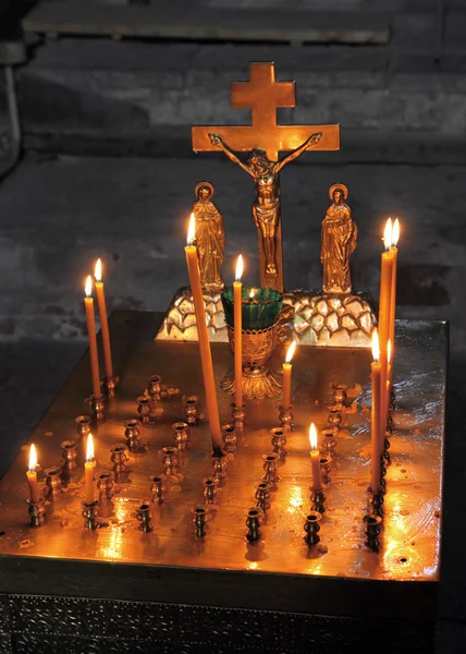 Candles and crucifix in church — Stock Photo, Image