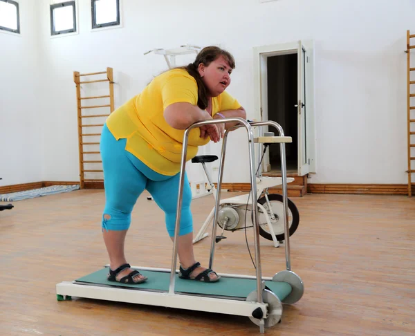 Moe overgewicht vrouw op trainer loopband — Stockfoto