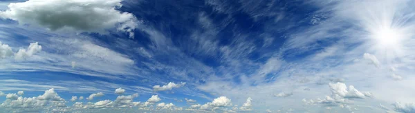 Panorama of beautiful sky with clouds and sun — Stock Photo, Image