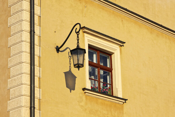 Close-up yellow building with window and street lamp