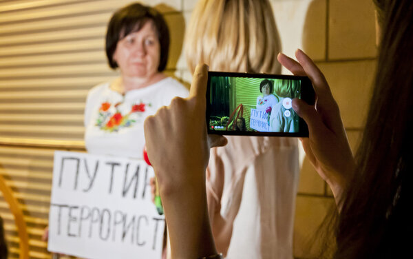 Люди помещают цветы в посольство Нидерландов в Киеве
