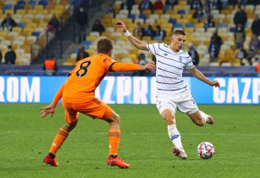 KYIV, UKRAINE - 20 Ekim 2020: Dinamo Kyiv 'li Vitaliy Mykolenko (R) UEFA Şampiyonlar Ligi maçında Juventus' lu Aaron Ramsey ile Kyiv Olimpiyskyi Stadyumu 'nda top için mücadele ediyor.
