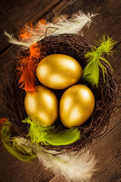 Golden eggs in the nest — Stock Photo, Image