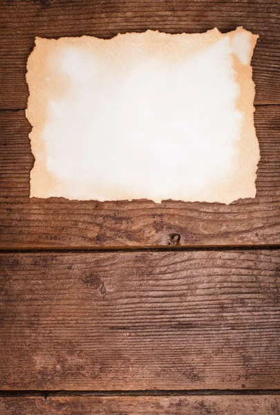 Aged paper on wood — Stock Photo, Image