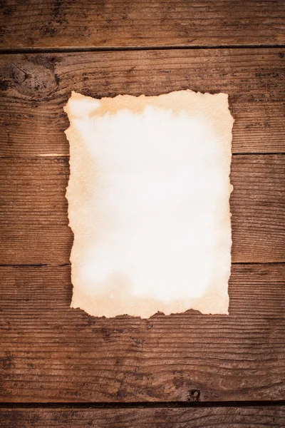 Aged paper on wood — Stock Photo, Image