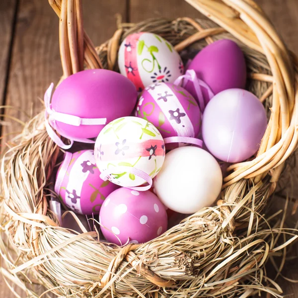 Easter purple eggs in basket — Stock Photo, Image