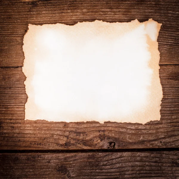 Aged paper on wood — Stock Photo, Image