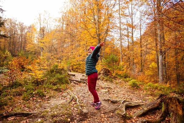 행복 한 여성 도보 여행자아름다운 가을 숲 속을 걷고 있습니다 — 스톡 사진