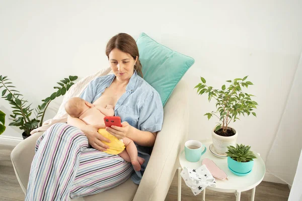 Comfortable and tranquil breastfeeding in cosy armchair at home — Stock Photo, Image