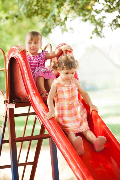 Girls on the slide — Stock Photo, Image