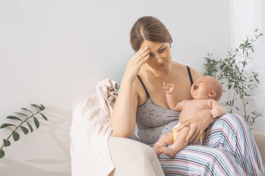 The young mom wants to breastfeed her newborn baby clipart