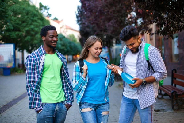 Wieloetniczni studenci z butelką bezalkoholowego wina musującego — Zdjęcie stockowe