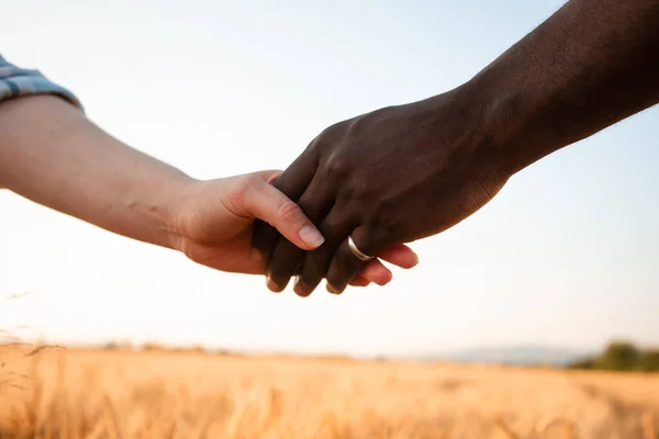 Multiracial relationship and friendsip concept. Two hands holding together. — Stock Photo, Image