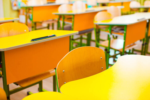 Chairs and desks in a deserted classroom in a school