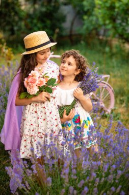Hasır şapkalı sevimli kız kardeşlerin romantik portresi
