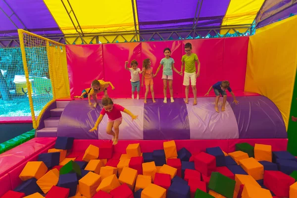 The children have a great time together in the trampoline park — Stock Photo, Image