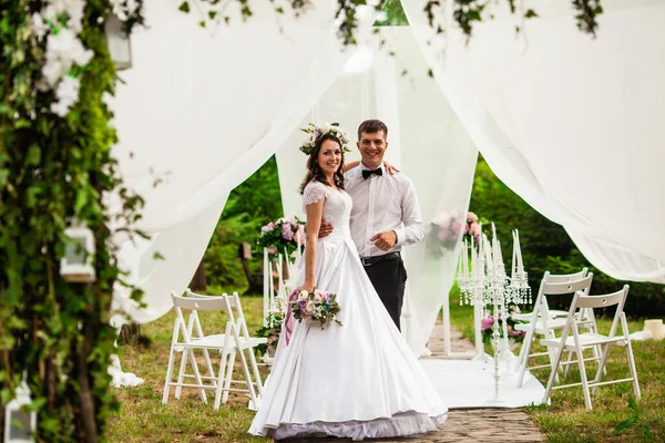 Ślub para pod łukiem kwiatów na ceremonii ślubnej — Zdjęcie stockowe