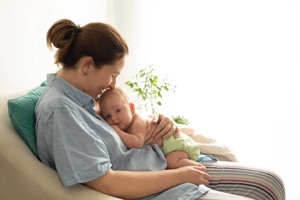 Woman with her baby rest in the chair after breastfeeding — Stock Photo, Image