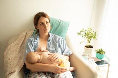 The young mom wants to breastfeed her newborn baby but have breast pain clipart