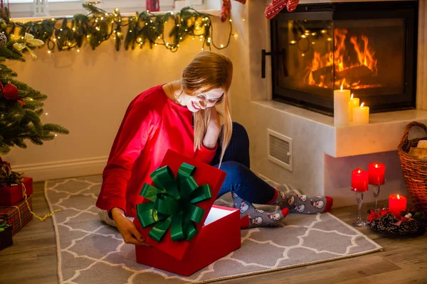 Woman open a red box gift. Magical Christmas time