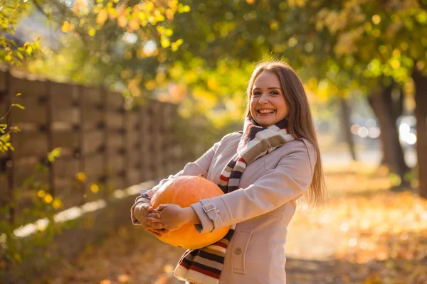 Portrait of happy smile woman with pumpkins in hand. Cozy autumn vibes Halloween, Thanksgiving day.