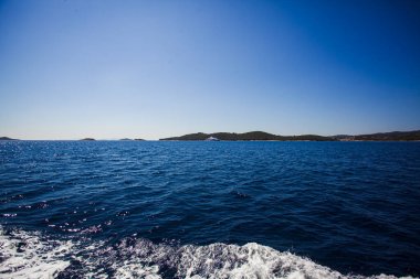 Beautiful minimalistic landscape, the surface of the sea under the blue sky. Natural abstract background and texture