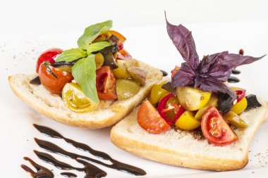 taze ekmek üzerinde sulu domates, pesto tepesi olarak