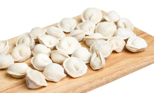 Some raw dumplings on the wooden board — Stock Photo, Image