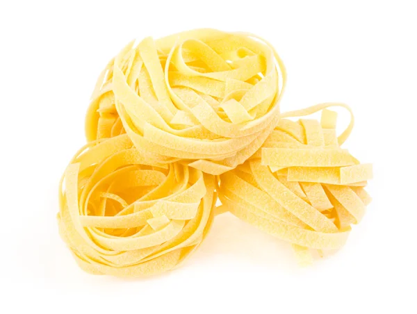 Nido di fettuccine di pasta isolata su fondo bianco — Foto Stock