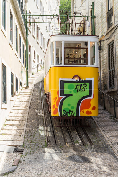LISBON, PORTUGAL - Jun 25: Traditional yellow and red trams down