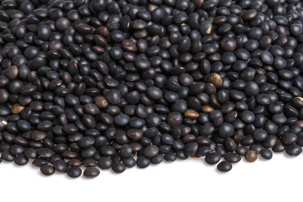 Heap of black lentil isolated on white — Stock Photo, Image