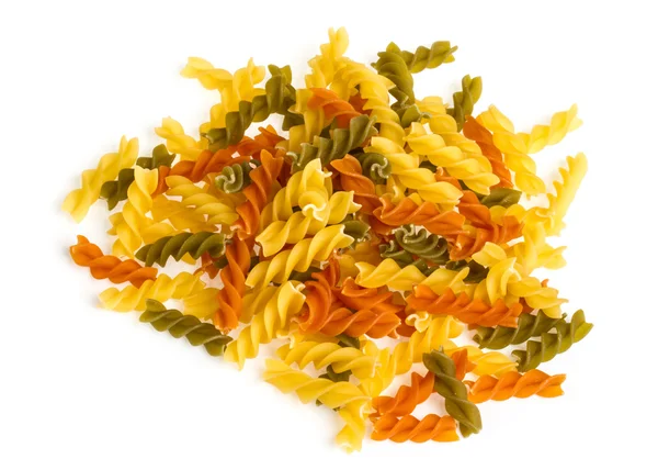 Uncooked pasta fusilli in different colours, white background — Stock Photo, Image