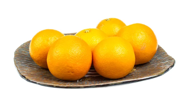 Hoop van sinaasappelen in de schotel — Stockfoto