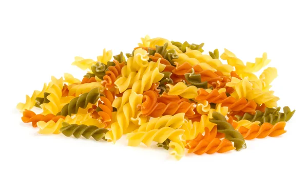 Uncooked pasta fusilli in different colours, white background — Stock Photo, Image