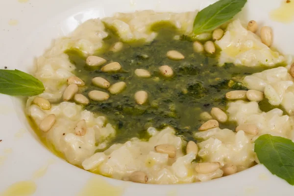 Photo of delicious risotto dish with herbs and cedar nut on whit — Stock Photo, Image
