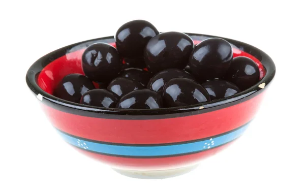 Olives black watered with olive oil in a bowl isolated on a whit Stock Image
