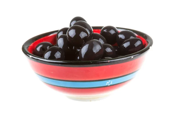 Olives black watered with olive oil in a bowl isolated on a whit — Stock Photo, Image