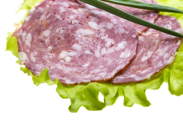 Italian sausages with salad leaves — Stock Photo, Image