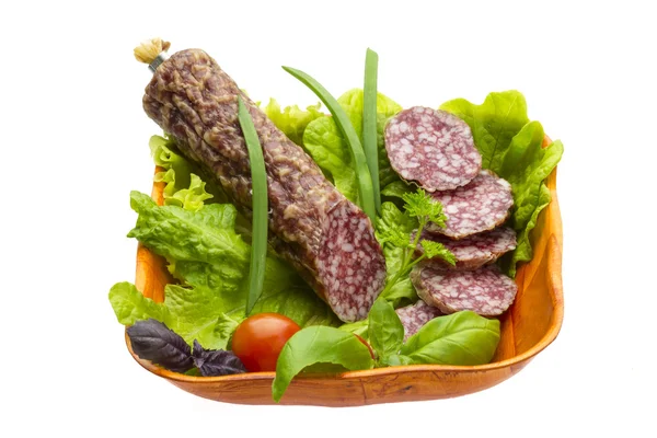 Ripe salami with salad, basil, onion and tomato — Stock Photo, Image