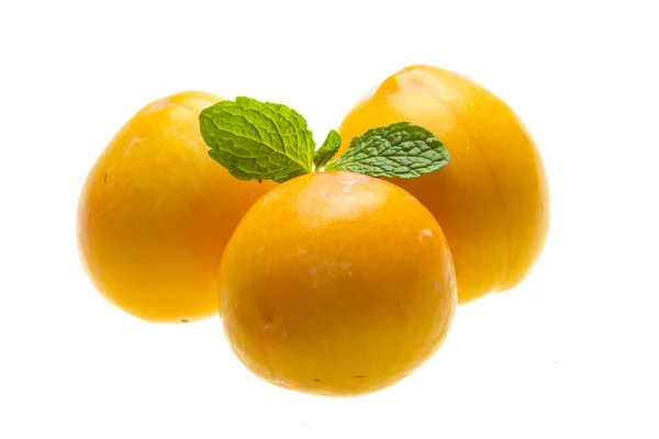 Bright ripe plum with mint — Stock Photo, Image