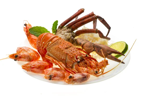 Spiny lobster, shrimps, crab legs and rice — Stock Photo, Image