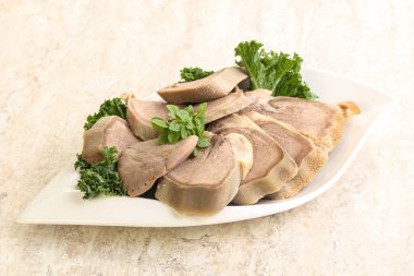 Dilimlenmiş domuz dili aperatifi. Fesleğen servis edildi.