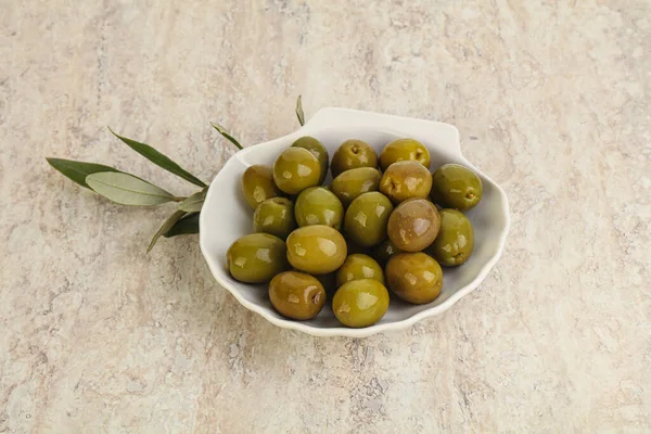 Tasty marinated olives in the bowl served branch