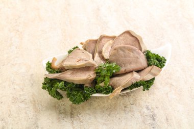 Dilimlenmiş domuz dili aperatifi. Fesleğen servis edildi.