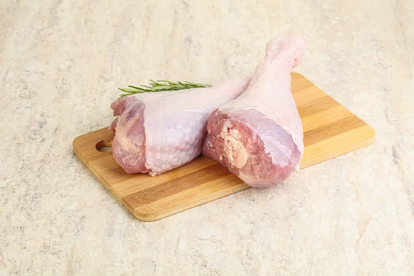Raw turkey leg for cooking served rosemary