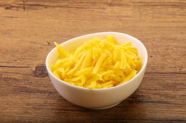 Yemek pişirmek için kasede dilimlenmiş sarı peynir.