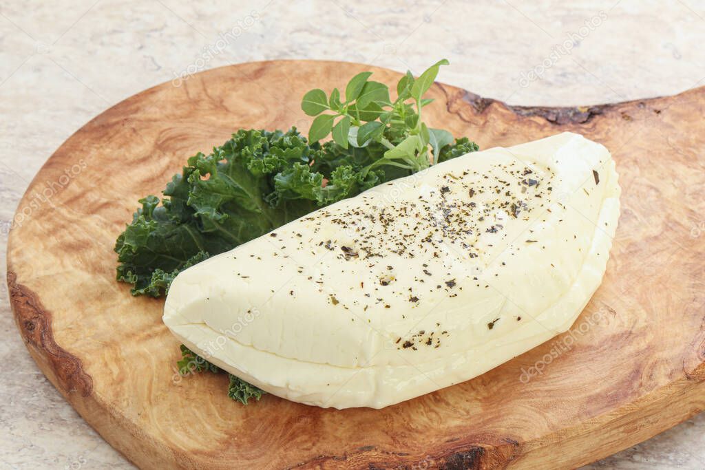 Raw haloumi cheese with spices for grill