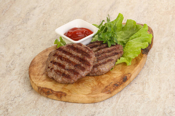 Grilled beef burger cutlet with tomato sauce